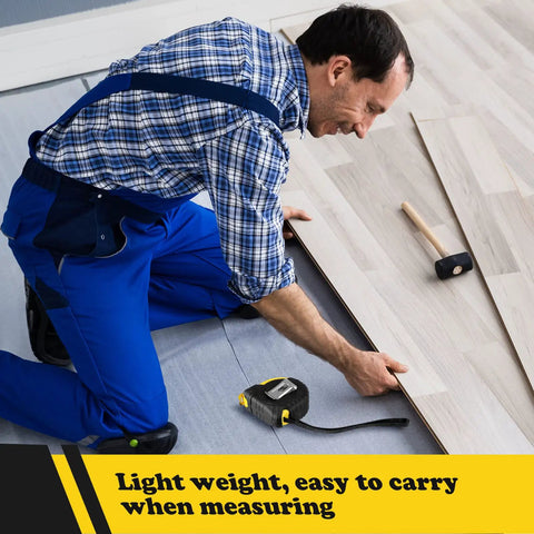 Person measuring flooring with 20 Pack 12 Ft Tape Measures Retractable With Fractions Easy Read Yellow Bulk Set