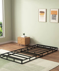 Twin Box Spring Low Profile Heavy Duty Platform Mattress Foundation in black, placed on a rug in a modern bedroom.