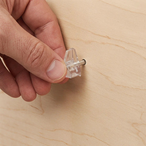 Hand installing 60 Piece Plastic Shelf Support Pegs With Studs 3mm 1/8 Inch Cabinet Shelf Pins for cupboard wall cabinet