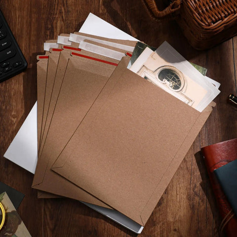 7x9 Inch Rigid Kraft Mailers Self Adhesive Flat Shipping Bags 200 Pack Bulk for office mailing on wooden desk