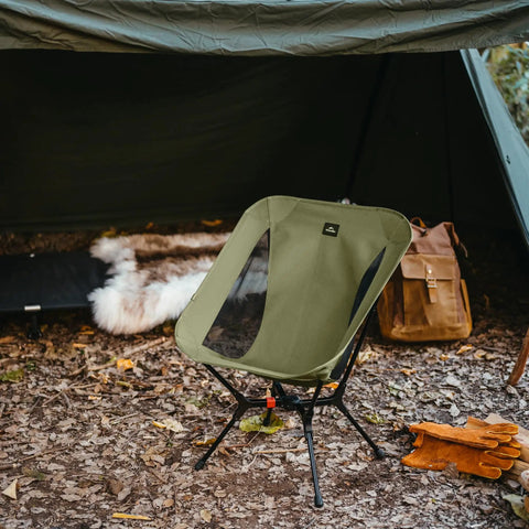 One Second Setup Camping Chair With Elastic Cord Frame and 441Lb Capacity set up outside tent on leafy ground