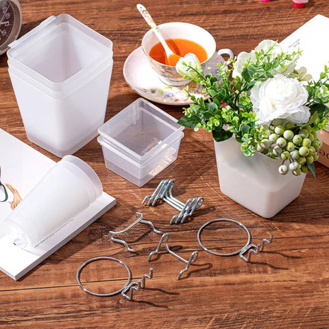 12 Pcs Pegboard Bins And Cups With Hooks And Loops Pegboard Basket Set arranged on a wooden table with flowers