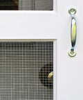 Close-up of a door with 24 Inch By 50 Feet 23 Gauge Galvanized Hardware Cloth With Quarter Inch Openings and metal handle.
