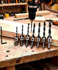 Seven Piece Heavy Duty Countersink Drill Bit Set Rock Solid High Speed Steel with L wrench on wooden workbench for carpentry tasks.