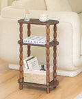 Three Tier Narrow Side Table With Storage For Small Spaces beside couch, holding cup, book, and basket, rustic brown finish
