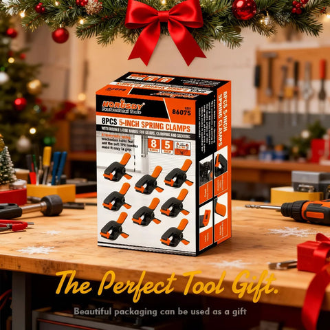 Front view of HORUSDY 8-pack 5-inch spring clamps box on workbench; orange and black plastic clamps.