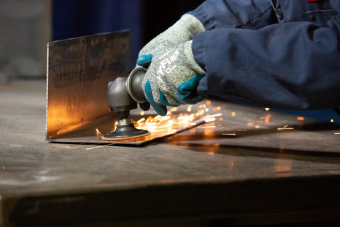 Worker using Roloc Non-Woven Surface Conditioning Disc 2 Inch Open-Web Abrasive for deburring metal sheet, quick-change backing.
