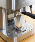 Top Tier Stainless Steel Espresso Machine With Reliable 19 Bar Italian Pump brewing espresso shot into clear glass.