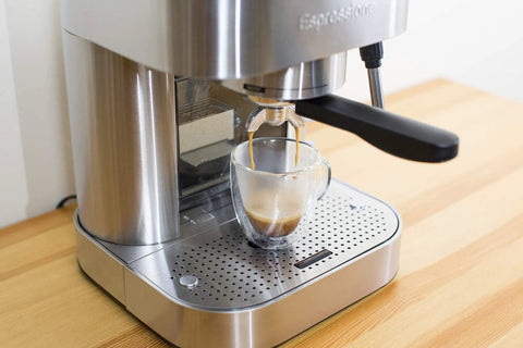 Top Tier Stainless Steel Espresso Machine With Reliable 19 Bar Italian Pump brewing espresso shot into clear glass.