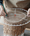Person using Clear Acrylic Center Finder Gauge For Circles 11.8 Inch Diameter Lathe Centering Tool on a wooden log