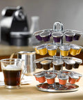 Chrome coffee pod holder with colorful pods on a kitchen counter next to coffee machine and mug, not Large Sliding Capsule Drawer