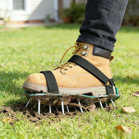 Universal Fit Lawn Aerator Shoes With Two Inch Spikes And Adjustable Straps in use on grass by person wearing boots