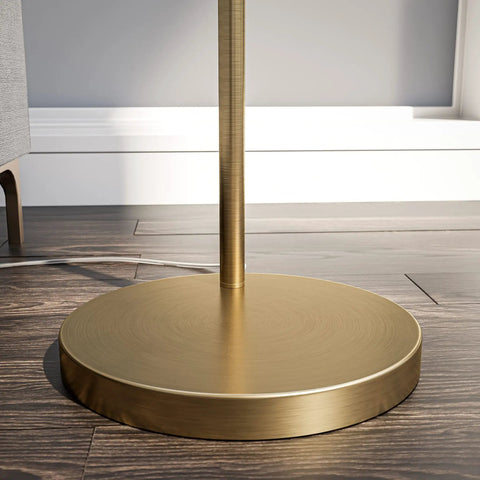 Brass Finish USB Floor Lamp With Built In Tray And USB Port base detail on wood floor showing circular design in modern style
