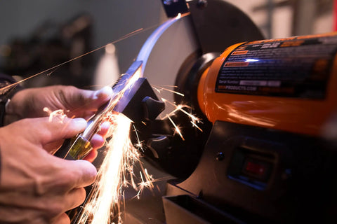 Eight Inch Bench Grinder Powered By A Beefy Four Point Eight Amp Motor Hitting 3450 RPM in action sharpening a knife.