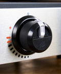 Close-up of the control knob on the Portable 17 Inch Tabletop Griddle With Stainless Front Plate And Powder Coated Steel.