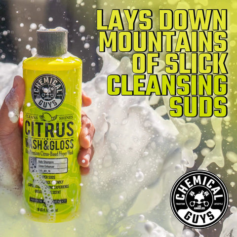 Hand holding Citrus Wash soap from Ultimate Car Wash Bucket Kit With Dirt Trap Insert, Microfiber Mitt, Soap, And Lid.