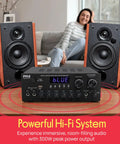 Home Karaoke Amp Receiver With Bluetooth Streaming And Two Hundred Watt Peak Power Dual Mic Inputs With Delay And Reverb Two Point Oh Channel Hi Fi Sound System USB A MP3 Player RCA And Aux displayed between two speakers