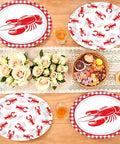 Rad Lobster Themed Oval Paper Plates 12 By 10 Inch 50 Pack Disposable Seafood Boil Dishes with red lobster design on a table.
