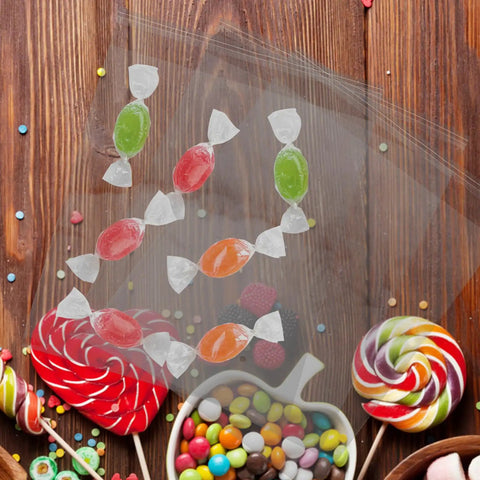 Transparent view of 100 Pack Self Sealing Candy Bags Resealable BOPP Bags for Baking Supplies with candies on wooden table