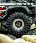 King Trekker 1.9 Inch S5 All Terrain Tires For One Tenth Scale Crawlers mounted on RC vehicle, outdoor rocky setting.