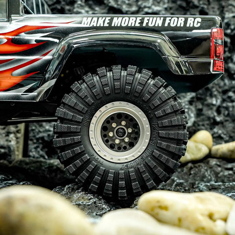King Trekker 1.9 Inch S5 All Terrain Tires For One Tenth Scale Crawlers mounted on RC vehicle, outdoor rocky setting.