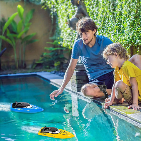 Father and son playing with the Triple Pack Remote Control RC Boat Set for Kids and Grownups, 2.4GHz Wireless Control, Fully Waterproof Hull