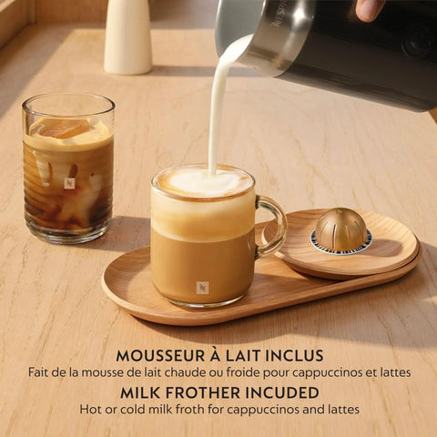 Pouring milk into coffee beside Vertuo Up Coffee And Espresso Maker With Aeroccino Milk Frother By Breville, Ink Black