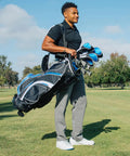 Person carrying S7 18 Piece Men's Golf Club Set With Titanium Driver, Fairway Woods, Hybrid, 5-SW Irons, Putter And Stand Bag