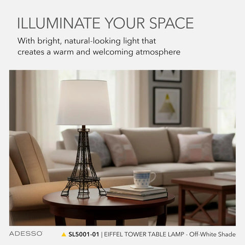 Parisian Eiffel Tower themed novelty table lamp with fabric shade on round wooden table in cozy living room setting.