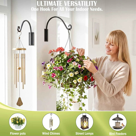 Heavy Duty Plant Hanger Bracket 16 Inch Black Outdoor Hand Forged Metal Hanging Bracket With 80 Lbs Capacity For Plants And Bird Feeders Built To Last Rock Solid Stable Weatherproof And Rust Resistant mounted on wall with flower pot and wind chimes.