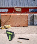 Micpointik T-Shaped Bubble Level, 2-Way Horizontal for spirit Level placed on concrete with brick and level tool.