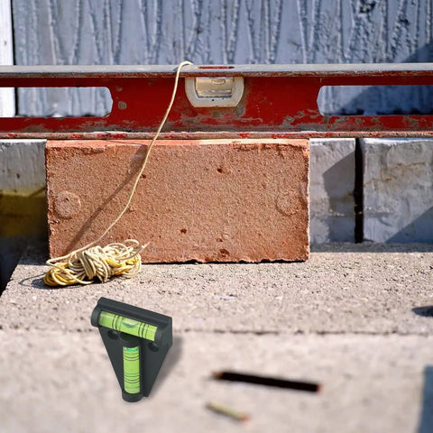 Micpointik T-Shaped Bubble Level, 2-Way Horizontal for spirit Level placed on concrete with brick and level tool.