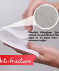 Hands holding waterproofing membrane tape showing flexible fiberglass with anti-fracture feature for tile underlayment.