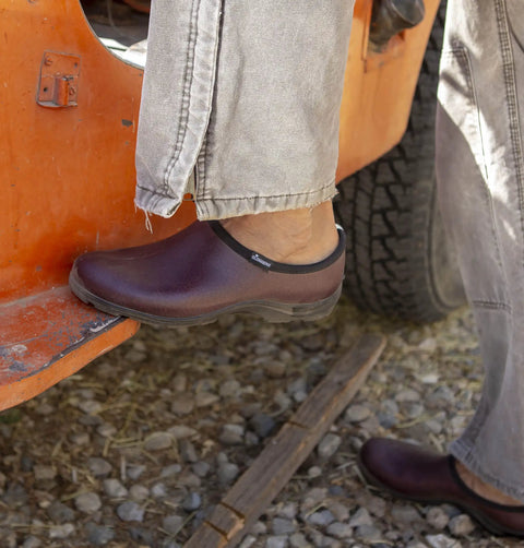 Mens Heavy Duty Waterproof Slip On Shoes For Outdoor Work And Garden Rain Featuring A Built Tough Comfort Support Insole With Durable Leather Print Upper For A Good As Gold Ride on gravel near a truck.