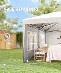 10x20 Pop Up Canopy Tent With Four Sidewalls set up in a backyard with table and chairs, showing stability features