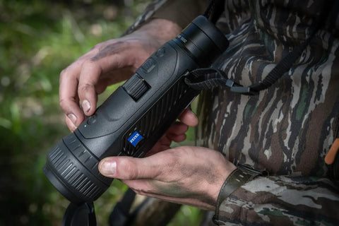 Person holding DTI Six Twenty Thermal Imaging Camera High Resolution Monocular for Night Hunting, close-up view.