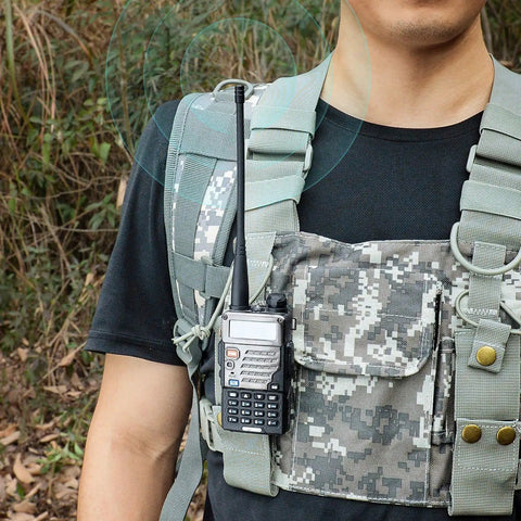 Person with handheld radio equipped with Dual Band Ham Radio Antenna 136-174MHz and 400-470MHz Omni Directional 3 dBi Gain