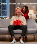 Man holding red gift with woman playfully covering his eyes, sitting on a couch, holiday setting, "Unique Gifts for the Most Loved Ones"