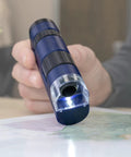 Pocket Microscope With LED 20x To 60x Magnification, Handheld STEM Toy For Curious Kids And Adults, Easy To Use For Exploring Insects, Leaves, Textures, And Everyday Science Adventures in blue plastic, shown in hand