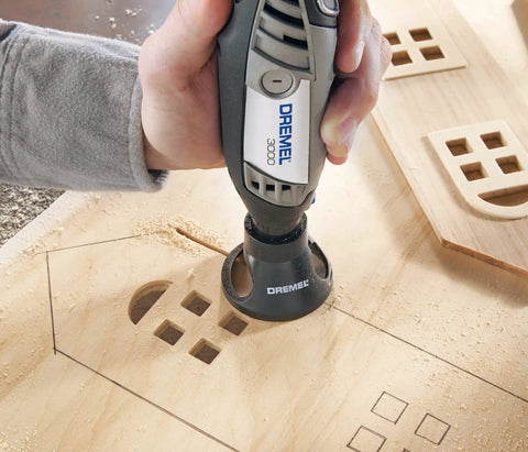 Person using a rotary tool with Multipurpose Cutting Bit for Rotary Tools One Eighth Inch Spiral Flute Ideal for Cutting Wood Plastic Fiberglass Drywall Laminate Aluminum and Vinyl Siding Ready To Use With Attachments And Pro Grade Cutting Performance on wood.