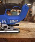 Refurbished 24V Max Cordless Jigsaw With Variable Speed And Keyless Blade Change, Blue And Black Finish, on wooden surface.