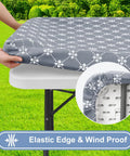 Rectangular Vinyl Table Cloth With Elastic Fitted Edges And Flannel Backing, Waterproof And Stain Resistant Cover That Stays Put On 6 Foot Folding Tables For Picnics Camping Indoor Or Outdoor Use Gray 30 By 72 Inches shown on a table outdoors.
