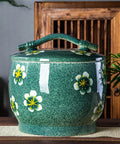 Kick Up Your Kitchen Game With This Handmade Ceramic Storage Jar With Lid For Rice And Pet Food, Retro Porcelain Cylinder Bin For Flour Coffee Beans And Dry Grains, Solid Pantry Keepers That Are Built Different And Look Fresh - Large green ceramic canister with floral design and lid.