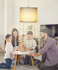 Family enjoying game night under Slick Adjustable Plug In Pendant Light With Authentic Beige Linen Shade in cozy living room.