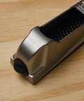 Close-up of 6 Inch Surform Pocket Plane Handy For One Handed Use With Quick Blade Tension on wooden surface