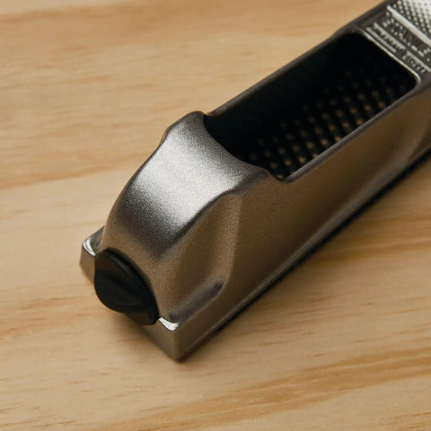 Close-up of 6 Inch Surform Pocket Plane Handy For One Handed Use With Quick Blade Tension on wooden surface