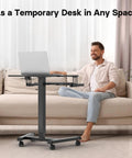 Mobile Standing Desk With Keyboard Tray And Wheels in use with laptop, Height Adjustable Portable Computer Workstation for Living Room