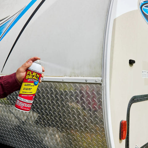 Person holding can of White 14 Oz Waterproof Rubber Spray On Sealant Coating That Stops Leaks Instantly Flexible After Drying Ideal For Gutters Wood RVs Campers Roofs Skylights Windows And More near RV