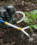 Backpack Manual Spreader Dispenser For Farming 20L Capacity With Bag next to plant, showing fertilizer distribution