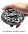 Hand holding magnetic dish with screws and bolts, part of Three Piece Magnetic Tray And Pick Up Tool Set With Magnetic Dish Extendable Tool.